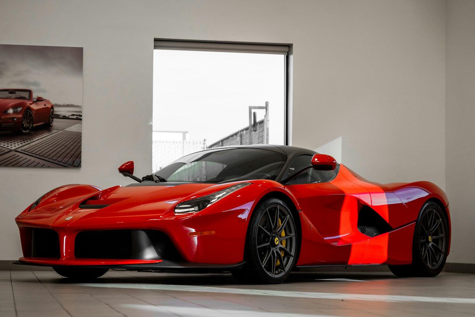Ferrari roșu lângă un perete alb
